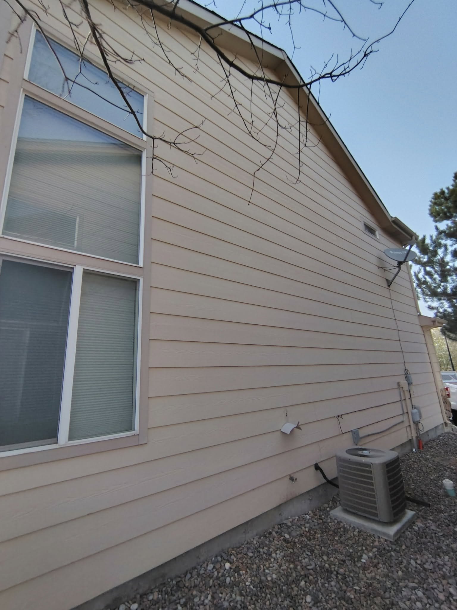 Cream siding close-up before Chess Remodels exterior repaint